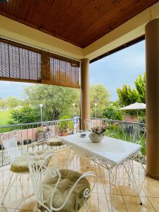 a patio with a table and chairs on a balcony at Villa Almonds in Sozopoli