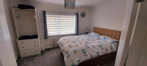 a small bedroom with a bed and a window at Private 2 bedroom house close to the beach in Paignton