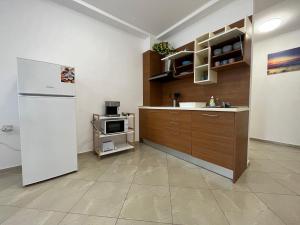 a kitchen with a refrigerator and a microwave at Апартаменти Меден Рид in Sozopol