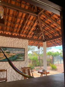 a porch with a wooden roof and a table and chairs at Flats Macapá Meu Amor in Luis Correia