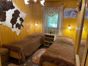 Pokój z dwoma łóżkami z głową krowy na ścianie w obiekcie Grunok (Adults only) w mieście Pilipets