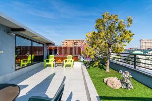 a patio with chairs and a tree on a roof at Joan Apartments & Spa in Skopje