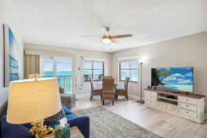 a living room with a tv and a couch at Emerald Isle 604 in St. Pete Beach