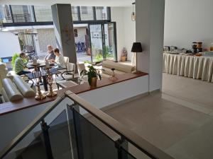 a group of people sitting at tables in a restaurant at Apartments Mite in Ohrid