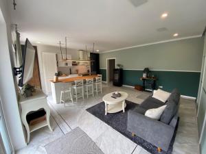 a living room and kitchen with a couch and a table at Hof Arche in Neuenkirchen-Vörden