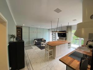 a kitchen and living room with a table and a couch at Villa Arche 3 in Neuenkirchen-Vörden