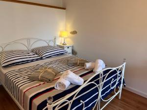 a bedroom with a bed with towels on it at Gaya apartments in Šibenik