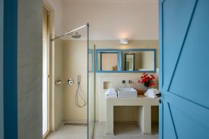 a bathroom with a shower and a sink and a mirror at Masseria Cuturi in Manduria