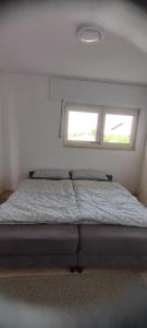 1 dormitorio con 1 cama y 2 ventanas en Schöne sonnige Wohnung, en Jüchen