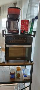 a microwave sitting on a shelf with food on it at Schöne sonnige Wohnung in Jüchen