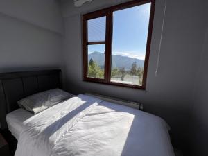 a bedroom with a bed and a window at Shen Home Life in Trabzon