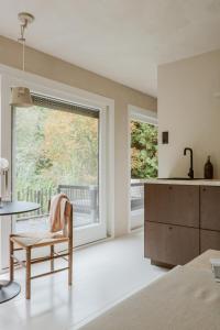 a bedroom with a window and a table and a chair at Cabin Water Zuidermeer in Zuidermeer