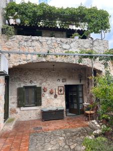 a stone house with a patio in front of it at Gaya apartments in Šibenik