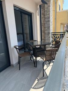a patio with a table and chairs on a balcony at Miran San in Donji Štoj