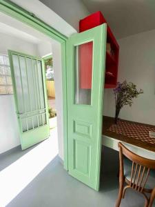 a green door in a room with a table at Anastasia, downtown village house in Amaliás