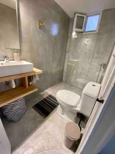 a bathroom with a toilet and a shower and a sink at Anastasia, downtown village house in Amaliás