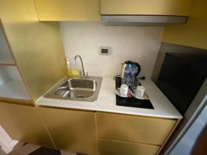 a small kitchen with a sink and a counter top at Espana Resort Pattaya Jomtien Beach by Jomkwan in Jomtien Beach