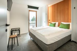 Ένα ή περισσότερα κρεβάτια σε δωμάτιο στο B-Lodge Kärnten