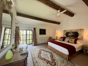 a bedroom with a king sized bed and a dresser at Villa Hautvallon in Gordes