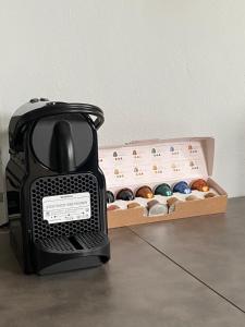 a black blender sitting next to a box of donuts at Fabulous Villa in Monemvasia