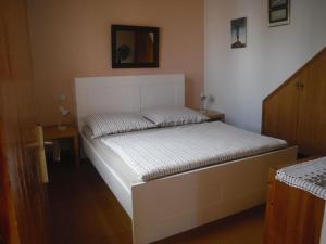 a bed in a bedroom with a white bed frame at Casa Joana in Cala Santanyi