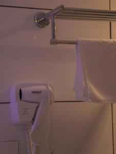 a hair dryer in a bathroom with a towel at Tribes hotel in Sohar