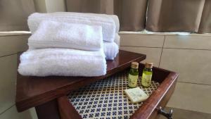 a wooden table with towels and two bottles of soap at Podere Il Ritorno in Portoferraio