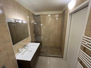 a bathroom with a sink and a shower at Rêve de sable appartement avec jardin et parking in Menton