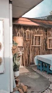 a building with a table and a fence at Brussels Homestay Kost in Balige