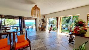 a living room with a view of the ocean at Villa c'est la vie in Nosy Komba