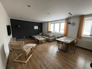 a living room with a couch and a table at Elegantný Byt v Srdci Mesta in Trenčín