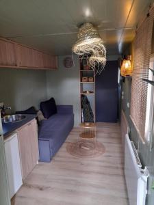 a living room with a couch and a table at Volcan Nature in Saint-Pierre-le-Chastel