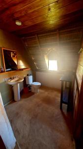 a bathroom with a toilet and a sink at Chez Peter Pan Anakao in Anakao