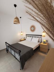 a bedroom with a black bed and a stone wall at Mantalena's house in Antiparos