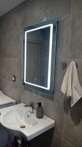 a bathroom with a sink and a mirror at Mantalena's house in Antiparos