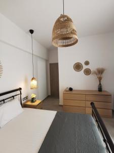 a bedroom with a bed and a pendant light at Mantalena's house in Antiparos