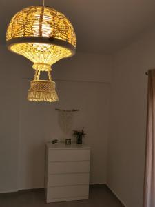 a large chandelier hanging over a dresser in a room at Mantalena's house in Antiparos