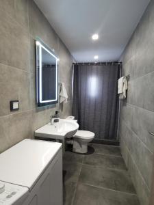 a bathroom with a sink and a toilet at Mantalena's house in Antiparos