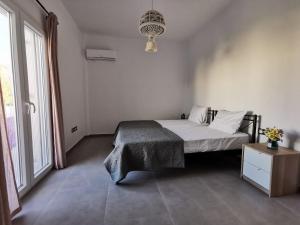 a bedroom with a bed and a large window at Mantalena's house in Antiparos