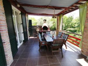 a patio with a table and chairs and a grill at The Forest House Krk 1 in Kras
