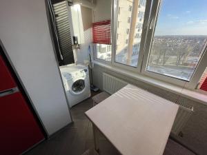 eine Waschküche mit einer Waschmaschine und einer weißen Bank in der Unterkunft Studio apartment on Vatutina in Winnyzja