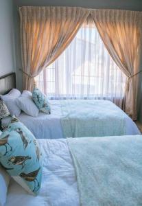 a bedroom with two beds and a window at Entire Self catering Home in Springs in Springs