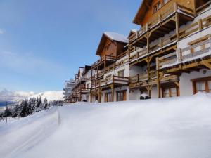 a snow covered slope in front of a ski lodge at Hosteria del Cerro in San Carlos de Bariloche