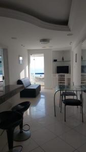 a living room with a couch and a table and chairs at Ondina Atlantic City in Salvador