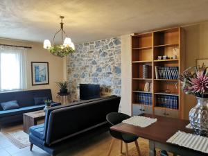 a living room with a couch and a table at Armonia Petra House in Kavála