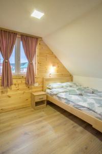 um quarto com uma cama grande e uma janela em Fenix em Žabljak