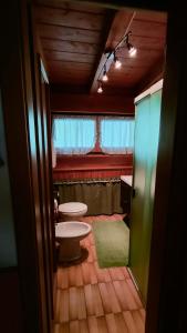 a bathroom with two toilets in a room at Appartamento Fronte Piste in Auronzo di Cadore