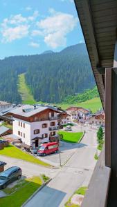 a view of a town with cars parked in a parking lot at Appartamento Fronte Piste in Auronzo di Cadore