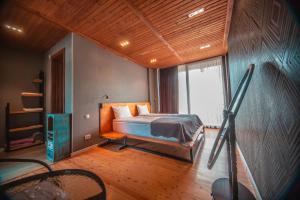 A bed or beds in a room at Vache Hotel