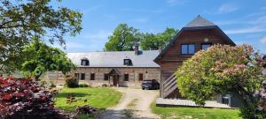 an old brick house with a gambrel roof at nid cauchois in Betteville